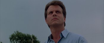 Movie still from “Twister” (1996), directed by Jan de Bont – A person wearing a blue shirt; Close Up shot, Low angle