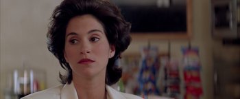 Movie still from “Twister” (1996), directed by Jan de Bont – A person wearing a white shirt; Close Up shot, Over the shoulder angle