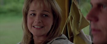 Movie still from “Twister” (1996), directed by Jan de Bont – A person smiling for the camera; Close Up shot, Over the shoulder angle