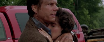 Movie still from “Twister” (1996), directed by Jan de Bont – A man and a woman embracing each other; Close Up shot, Low angle