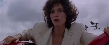 Movie still from “Twister” (1996), directed by Jan de Bont – A person with curly hair wearing a suit; Close Up shot, Low angle