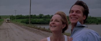 Movie still from “Twister” (1996), directed by Jan de Bont – Two women smiling and laughing on a dirt road; Close Up shot, Low angle