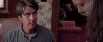 Movie still from “Twister” (1996), directed by Jan de Bont – A person sitting in a room; Close Up shot, Over the shoulder angle