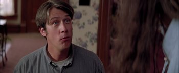 Movie still from “Twister” (1996), directed by Jan de Bont – A young man with blue eyes stares into the distance; Close Up shot, Over the shoulder angle