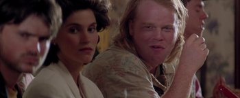 Movie still from “Twister” (1996), directed by Jan de Bont – A man and a woman sitting next to each other in a room; Close Up shot, Over the shoulder angle