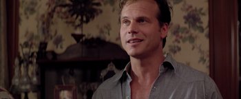 Movie still from “Twister” (1996), directed by Jan de Bont – A person wearing a gray shirt; Close Up shot, Low angle