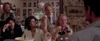 Movie still from “Twister” (1996), directed by Jan de Bont – Two women and a man sitting at a dining table; Medium shot, Over the shoulder angle