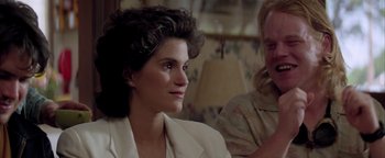 Movie still from “Twister” (1996), directed by Jan de Bont – A woman sitting next to another woman in front of a lamp; Close Up shot, Over the shoulder angle