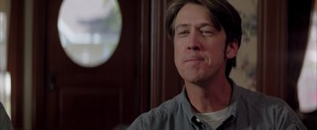 Movie still from “Twister” (1996), directed by Jan de Bont – A person sitting in front of a window; Close Up shot, Over the shoulder angle