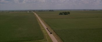 Movie still from “Twister” (1996), directed by Jan de Bont – An aerial view of a road with a truck on it; Extreme Wide shot, High angle