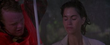 Movie still from “Twister” (1996), directed by Jan de Bont – A woman with her eyes closed under an umbrella in the rain; Close Up shot, Low angle