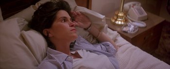 Movie still from “Twister” (1996), directed by Jan de Bont – A woman laying on a bed looking up at the sky; Close Up shot, High angle