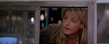 Movie still from “Twister” (1996), directed by Jan de Bont – A woman looking out of a window at night; Close Up shot, Over the shoulder angle