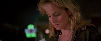 Movie still from “Twister” (1996), directed by Jan de Bont – A person looking down at a piece of paper; Close Up shot, Low angle