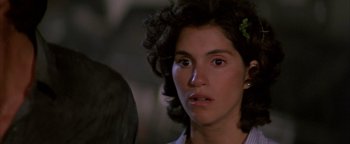 Movie still from “Twister” (1996), directed by Jan de Bont – A person with a flower in their hair; Close Up shot, Over the shoulder angle