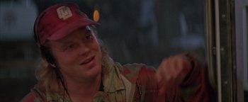 Movie still from “Twister” (1996), directed by Jan de Bont – A man wearing a red hat and a red shirt; Close Up shot, Over the shoulder angle