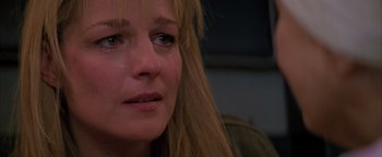 Movie still from “Twister” (1996), directed by Jan de Bont – A person with a tear in her eye; Close Up shot, Low angle