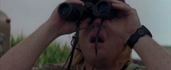 Movie still from “Twister” (1996), directed by Jan de Bont – A man looking through a pair of binoculars; Close Up shot, Over the shoulder angle