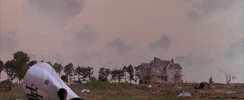 Movie still from “Twister” (1996), directed by Jan de Bont – An old house sitting on top of a hill; Extreme Wide shot, Low angle