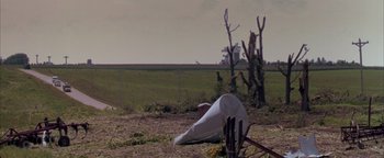 Movie still from “Twister” (1996), directed by Jan de Bont – An object that has been placed on top of a field; Extreme Wide shot, Low angle