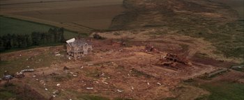 Movie still from “Twister” (1996), directed by Jan de Bont – An aerial view of a house that has been demolished; Extreme Wide shot, High angle