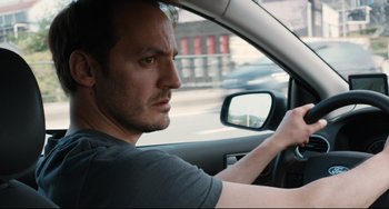 Movie still from “Two Days, One Night” (2014), directed by Jean-Pierre Dardenne – A person in a car; Close Up shot, Over the shoulder angle