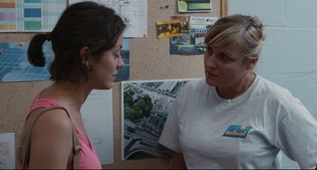 Movie still from “Two Days, One Night” (2014), directed by Jean-Pierre Dardenne – Two women are talking in front of a wall; Medium shot, Over the shoulder angle
