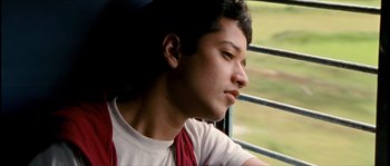 Movie still from “Udaan” (2010), directed by Vikramaditya Motwane – A young man sitting in a car looking out the window; Close Up shot, Low angle