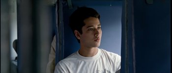 Movie still from “Udaan” (2010), directed by Vikramaditya Motwane – A young man looking into a mirror while wearing a white t - shirt; Close Up shot, High angle