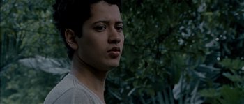 Movie still from “Udaan” (2010), directed by Vikramaditya Motwane – A young man is standing in front of a tree; Close Up shot, Low angle
