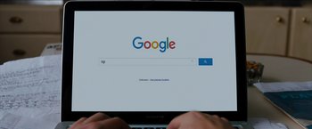 Movie still from “Under the Silver Lake” (2018), directed by David Robert Mitchell – Someone is looking at the google homepage on a computer screen; Extreme Close Up shot, High angle