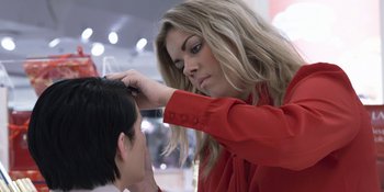 Movie still from “Under the Skin” (2013), directed by Jonathan Glazer – A woman is cutting a mans hair with scissors; Close Up shot, Over the shoulder angle