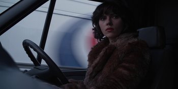 Movie still from “Under the Skin” (2013), directed by Jonathan Glazer – A person sitting in a car; Close Up shot, Over the shoulder angle