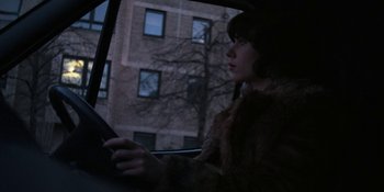Movie still from “Under the Skin” (2013), directed by Jonathan Glazer – A woman in a fur coat looking out of a car window; Close Up shot, Over the shoulder angle
