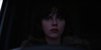 Movie still from “Under the Skin” (2013), directed by Jonathan Glazer – A person wearing a fur coat; Close Up shot, Over the shoulder angle