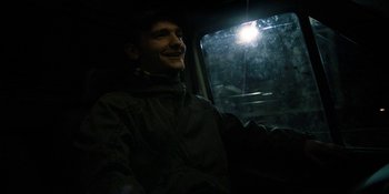 Movie still from “Under the Skin” (2013), directed by Jonathan Glazer – A man sitting in the back seat of a car; Close Up shot, Low angle