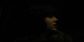 Movie still from “Under the Skin” (2013), directed by Jonathan Glazer – A woman in a fur coat looking to her left; Close Up shot, Low angle