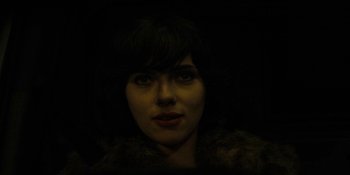 Movie still from “Under the Skin” (2013), directed by Jonathan Glazer – A person wearing a fur coat; Close Up shot, Low angle