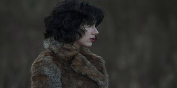 Movie still from “Under the Skin” (2013), directed by Jonathan Glazer – A person wearing a fur coat; Close Up shot, Low angle