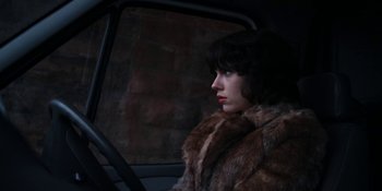 Movie still from “Under the Skin” (2013), directed by Jonathan Glazer – A woman sitting in the passenger seat of a car; Close Up shot, Low angle