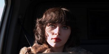 Movie still from “Under the Skin” (2013), directed by Jonathan Glazer – A person wearing a fur coat; Close Up shot, Low angle