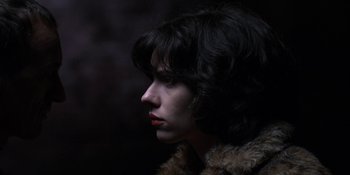 Movie still from “Under the Skin” (2013), directed by Jonathan Glazer – A person wearing a fur coat; Close Up shot, Low angle