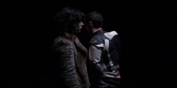 Movie still from “Under the Skin” (2013), directed by Jonathan Glazer – A man and a woman standing next to each other in the dark; Medium shot, Low angle