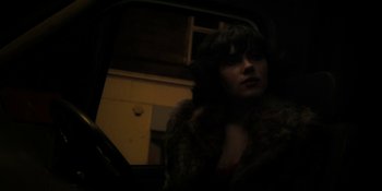 Movie still from “Under the Skin” (2013), directed by Jonathan Glazer – A woman in a fur coat looking out of a car window; Close Up shot, Low angle