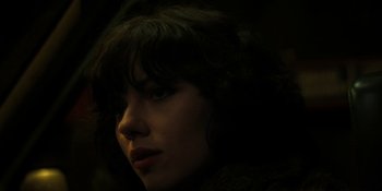Movie still from “Under the Skin” (2013), directed by Jonathan Glazer – A person's face in the dark; Close Up shot, Over the shoulder angle