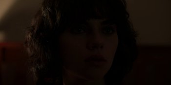 Movie still from “Under the Skin” (2013), directed by Jonathan Glazer – A woman's face in the dark; Close Up shot, Over the shoulder angle