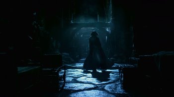 Movie still from “Underworld: Blood Wars” (2016), directed by Anna Foerster – A man in a long black coat is standing in the dark; Wide shot, Low angle