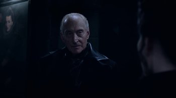 Movie still from “Underworld: Blood Wars” (2016), directed by Anna Foerster – An older man wearing a black jacket and a black tie; Close Up shot, Low angle