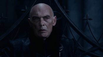 Movie still from “Underworld: Blood Wars” (2016), directed by Anna Foerster – A bald man wearing a black jacket and a black hat; Close Up shot, Low angle