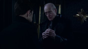 Movie still from “Underworld: Blood Wars” (2016), directed by Anna Foerster – A man in a black jacket is looking at a man in a black jacket; Close Up shot, Over the shoulder angle